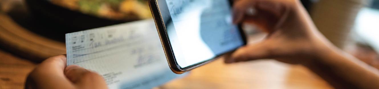 Person depositing a check with their smart phone and banking app.